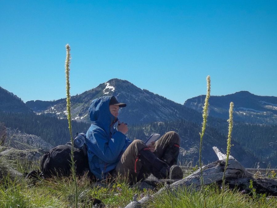 Noah Stanukinas 23 rests to journal at the top of the last mountain ridge climbed (photo courtesy of Stanukinas)