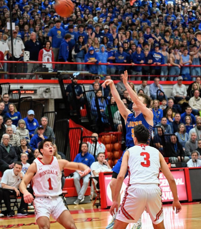 Jackson Niego 23 shoots jumpshot in rivalry game against Hinsdale Central High School on Jan. 20 (Klos/LION).