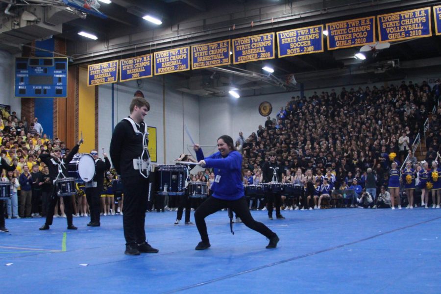 Principal Jen Tyrrell plays Taft Szyperskis 23 drums at the All-School Assembly during the drumline performance amid thousands of students (Wolf/LION).