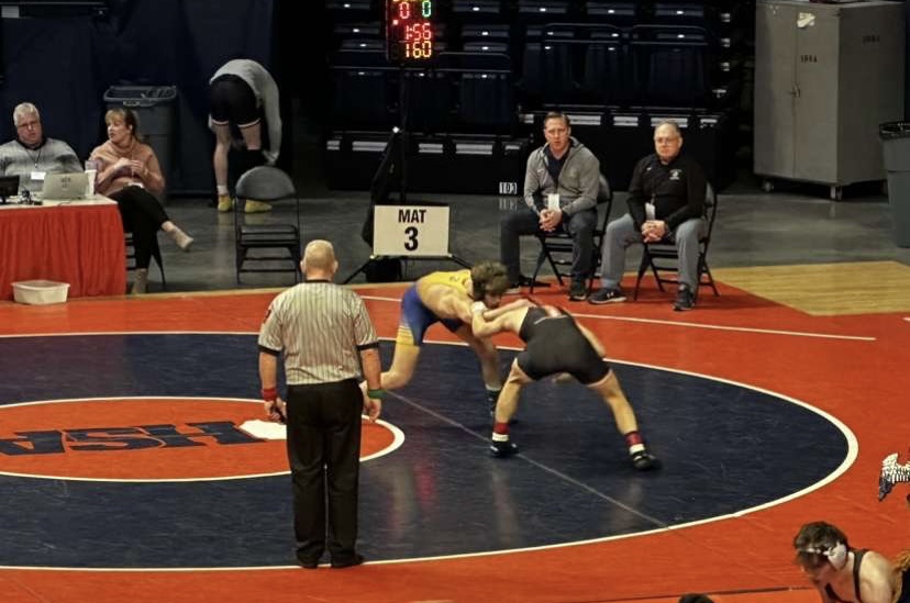 Gunnar Garelli ‘24 wrestles opponent from DeKalb High School at IHSA State Meet on Feb. 18, wins match 11-1 (photo courtesy of Garelli). 