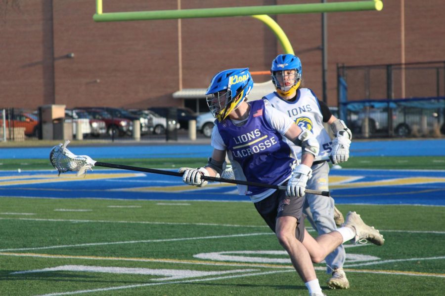 Jack Campbell ‘24 breaks away from teammate during a scrimmage at practice on Bennett field on March 7 (Wolf/LION).