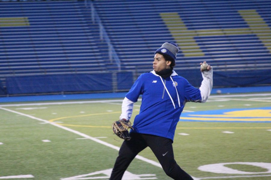 Kent State University commit Frederick Ragsdale III ‘23 works on tracking fly balls and throwing to the cutoff man at practice on Bennett Field on March 7 (Wolf/LION).