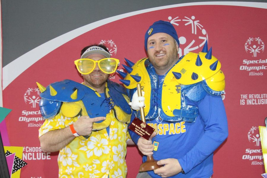 Brian Wolf and David Root collect trophy awarded to LT on March 11 at the Polar Plunge pre-party (Gartner/LION).