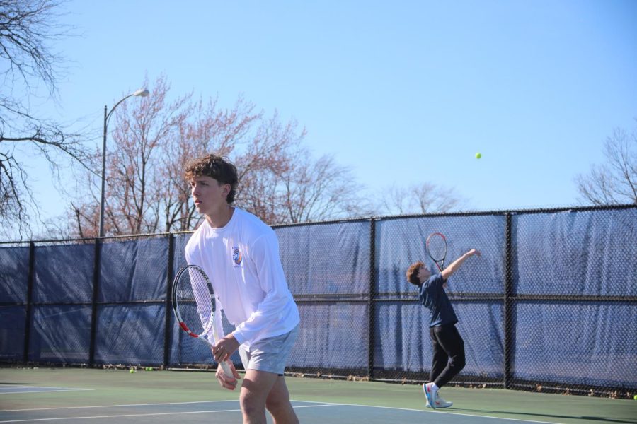 George Atseff ‘24 tosses the ball up in preparation to serve as Connor Spellman ‘23 awaits the return (Burke/LION). 
