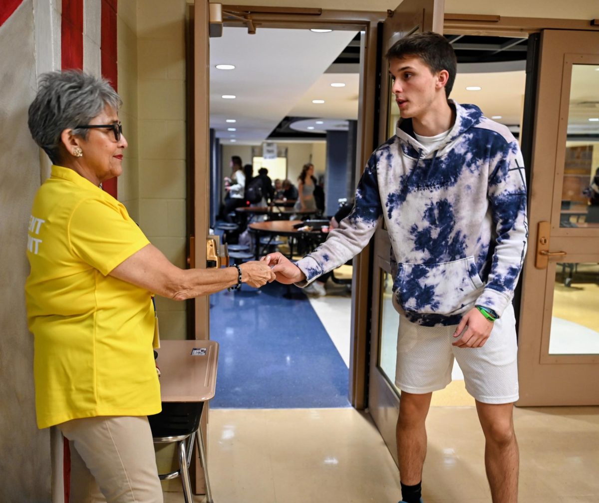Student Assistant Yolanda Rodriguez checks Carson Turners 24 student identification while leaving the lunch room (Klos/LION). 