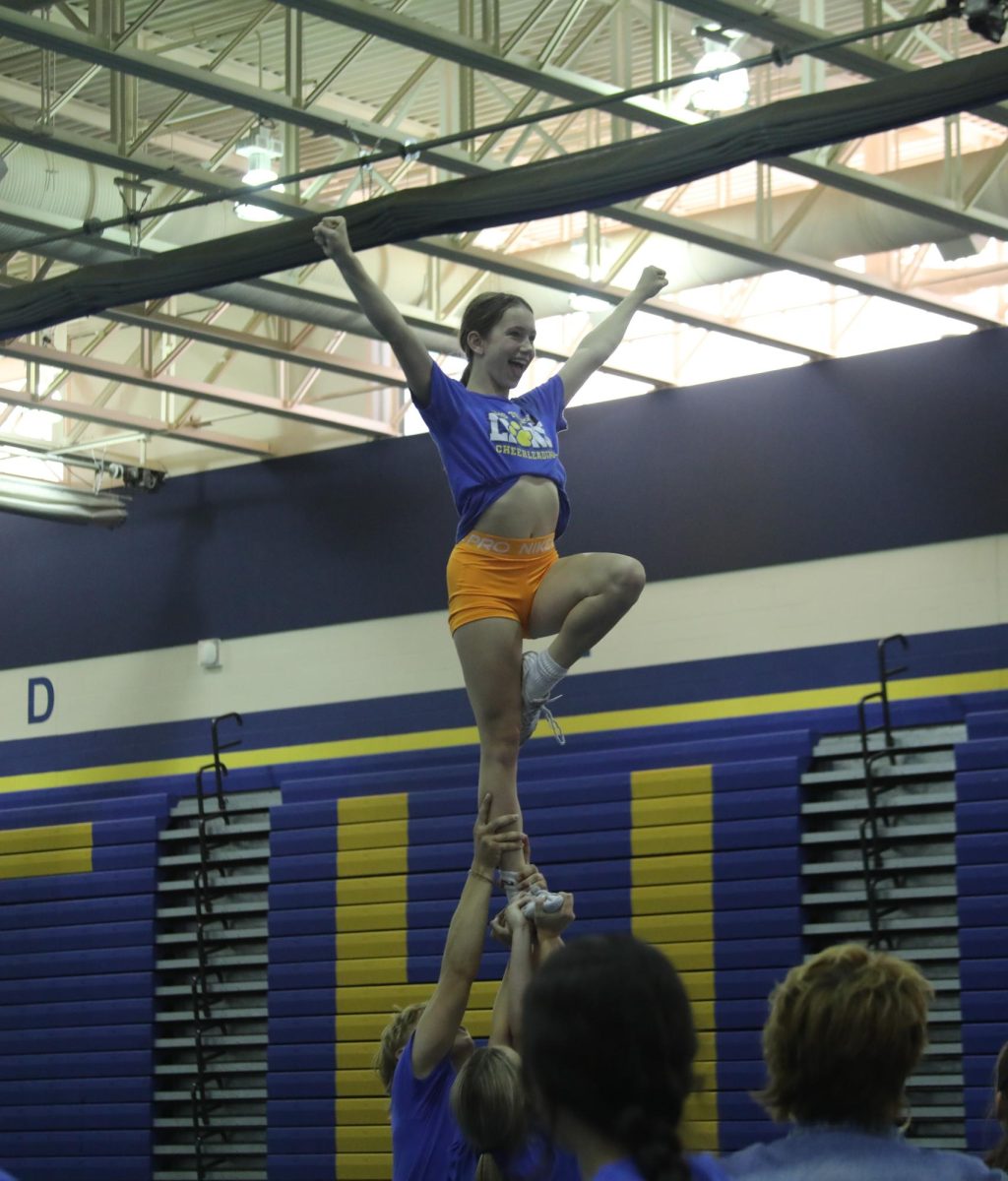 Flyer, Averie Grigus ‘27 is successfully lifted in a stunt during practice on Oct. 2 (James/LION).
