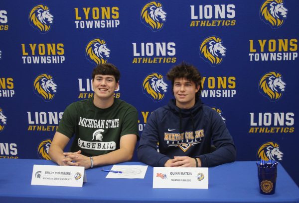 Brady Chambers ‘24 and Quinn Mateja ‘24 sign off on their commitments to continue their baseball careers at the collegiate level in the Vaughan Gym on Nov. 8 (Garrity/LION).
