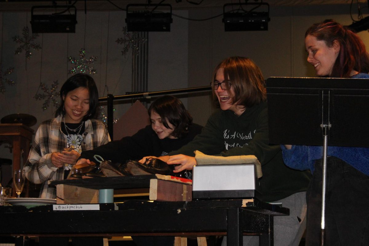 JoLi Klancir‘24, Ellie Watkins ‘24, Cooper Brown ‘25, and Gwendolyn Strickler 26 creating sound effects during rehearsal for the Christmas Carol radio play in the Reber Center (Ruppert/LION). 