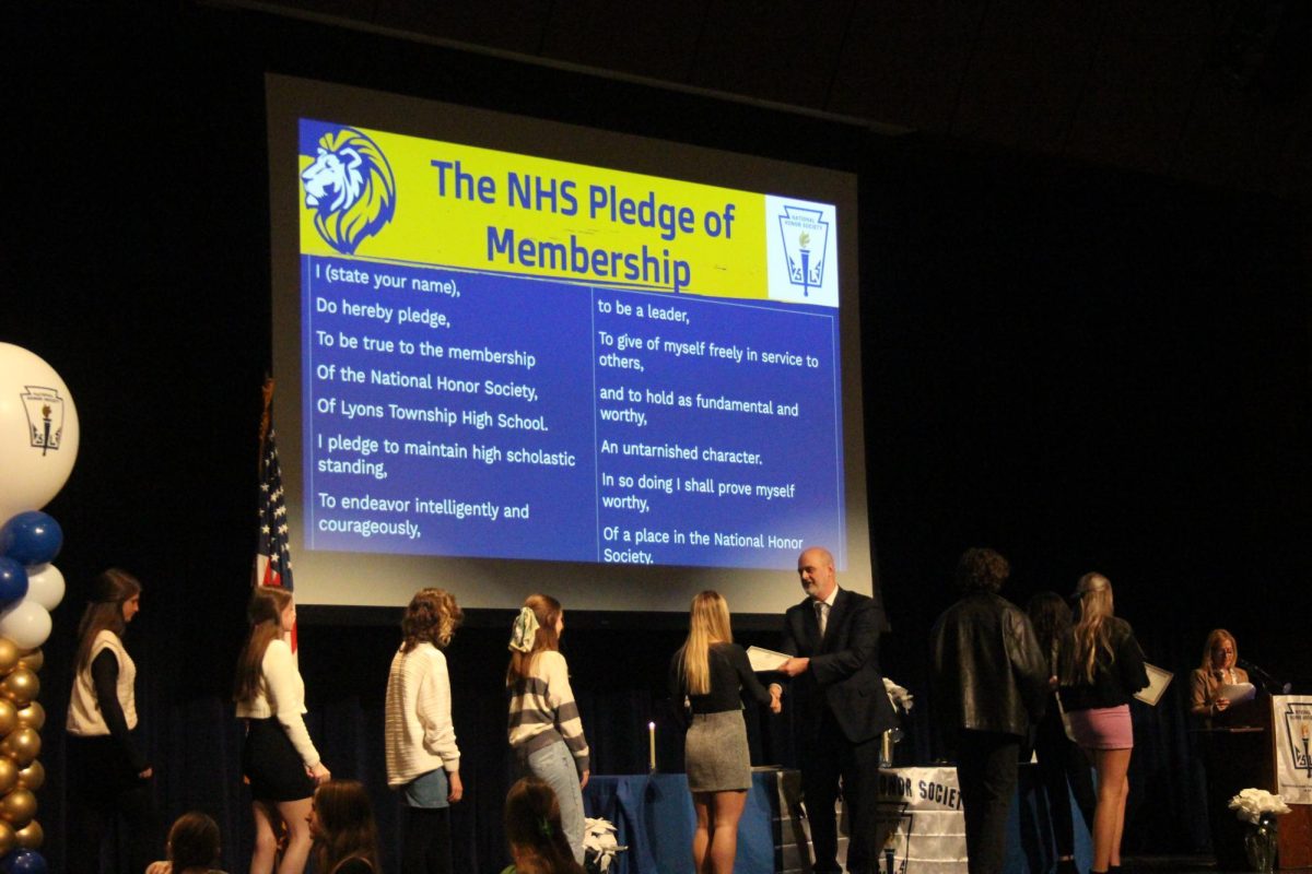 NHS inductees accept certificate from SC associate principal Greg Gardner on Nov. 28 (Gartner/LION).