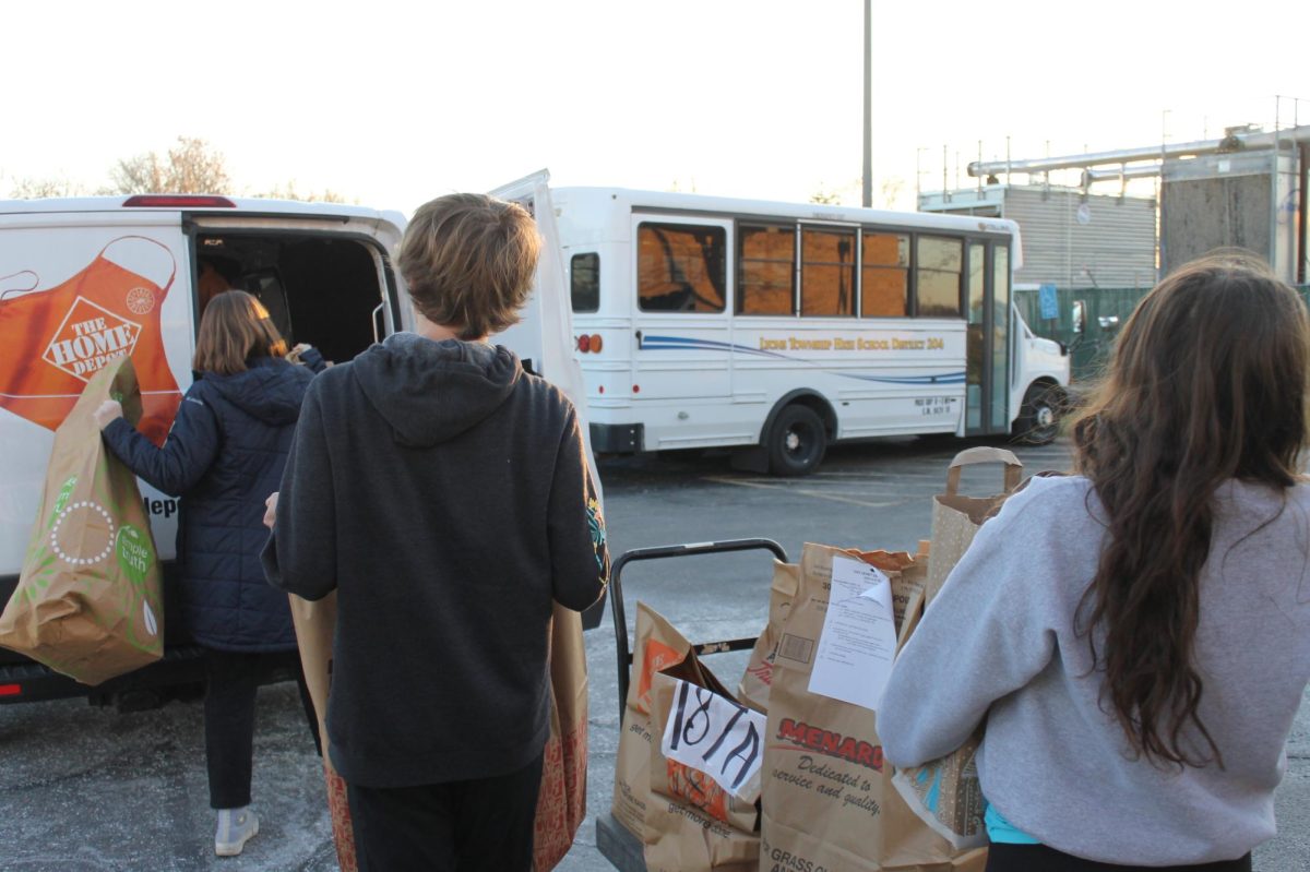 Student council members load bags of gifts into van to be delivered to Park District of LaGrange (Moran/LION).
