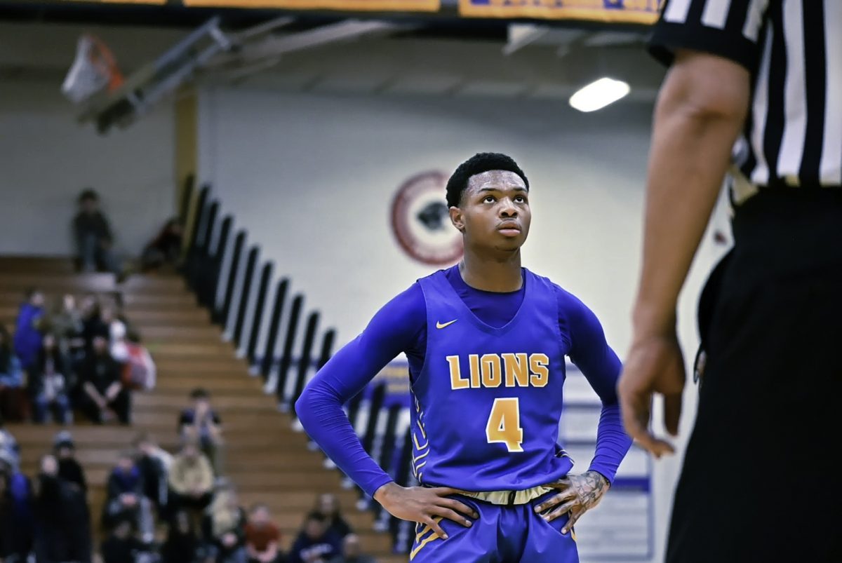 Caleb Greer ‘24 stares down the basket in anticipation of shooting a fourth quarter free-throw in the Regional Championship against Curie High School on Feb. 24 (Klos/LION). 
