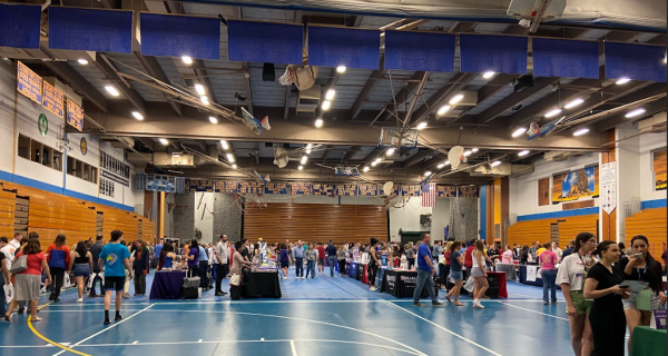 Students walk through the fieldhouse to visit various college tables during the 2023 fair (photo courtesy of Dailey). 
