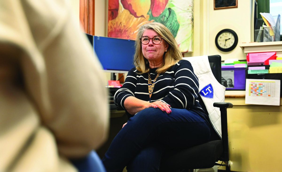 Retiring Senior Assistant Principal Kelly Dostal meets with student in her office at NC (Klos/LION).