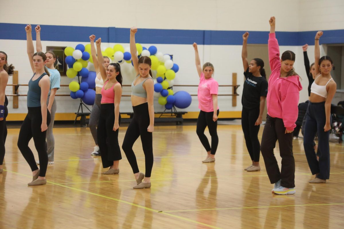 Poms team performs a routine while prepping for their next competition in the NC dance gym (Walsh/LION).