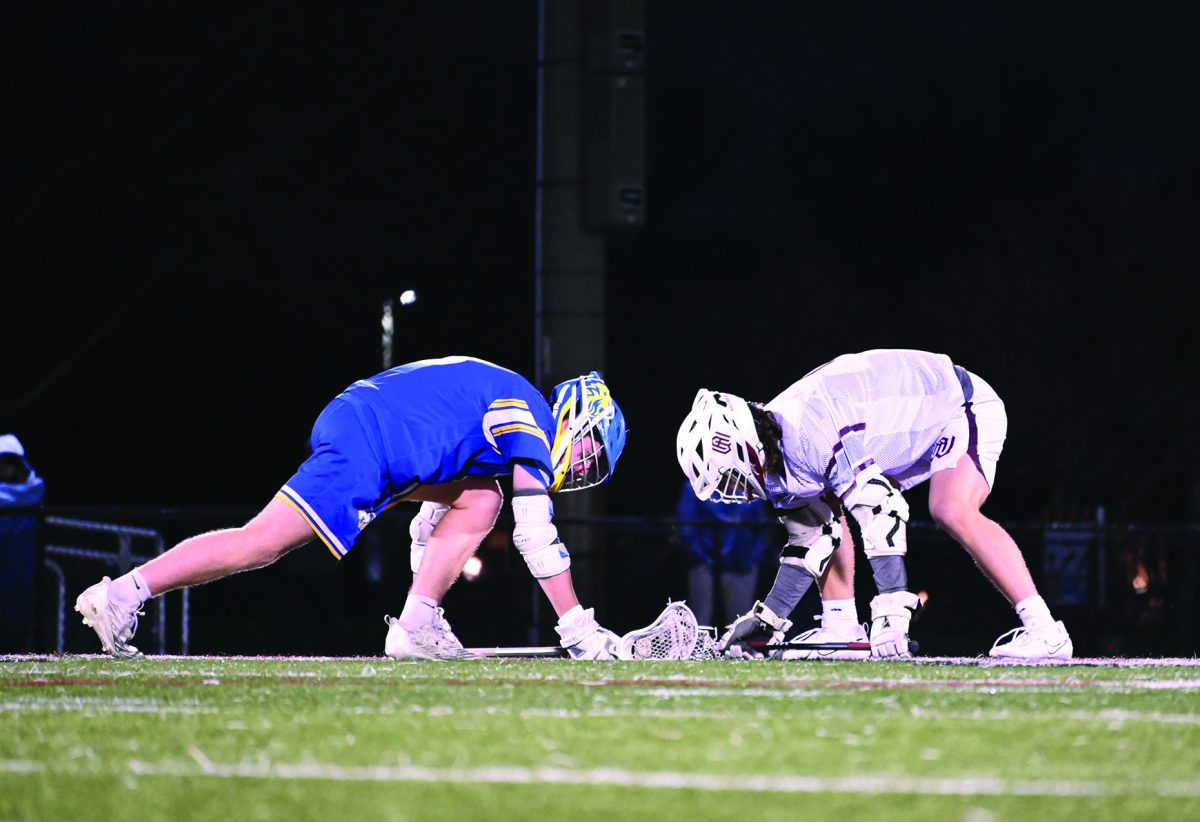 Connor+O%E2%80%99Malley+%E2%80%9824+faces+off+for+possession+of+the+ball+against+Wheaton+Academy+on+March+14+%28Klos%2FLION%29.+