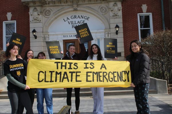 Rally participants hold climate emergency banner at La grange Village Hall
Sunrise Movement holds rally (photo courtesy of Riley McCarthy). 
