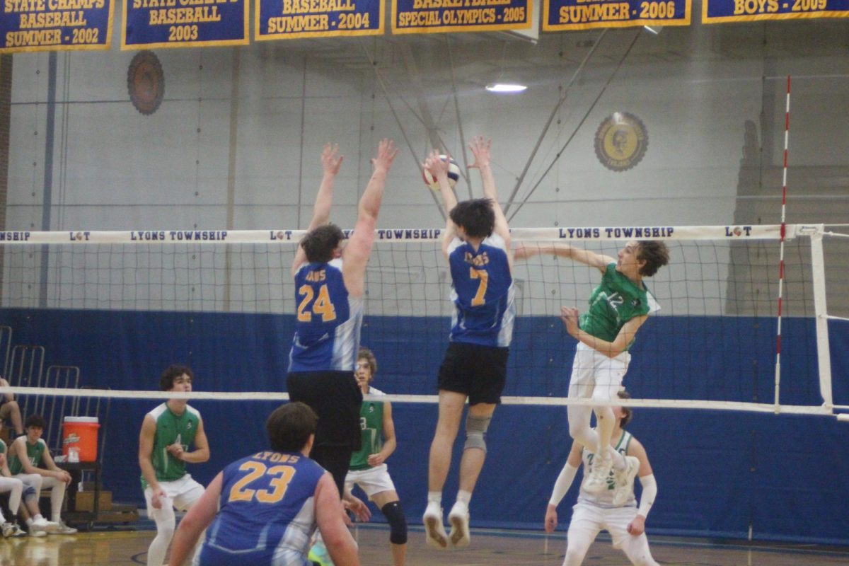 Tyler Chambers 25 (left) and Tommy Culver 24 (right) jump to block against York on April 15 (Kowalski/LION). 