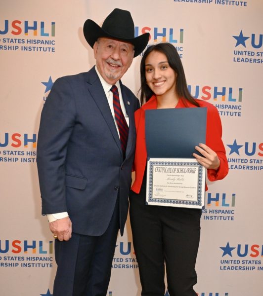 Merlay Rubio ‘24 receives the scholarship from Dr. Juan Andrade Jr. at the USHLI conference in February 2024 (photo courtesy of Rubio).
