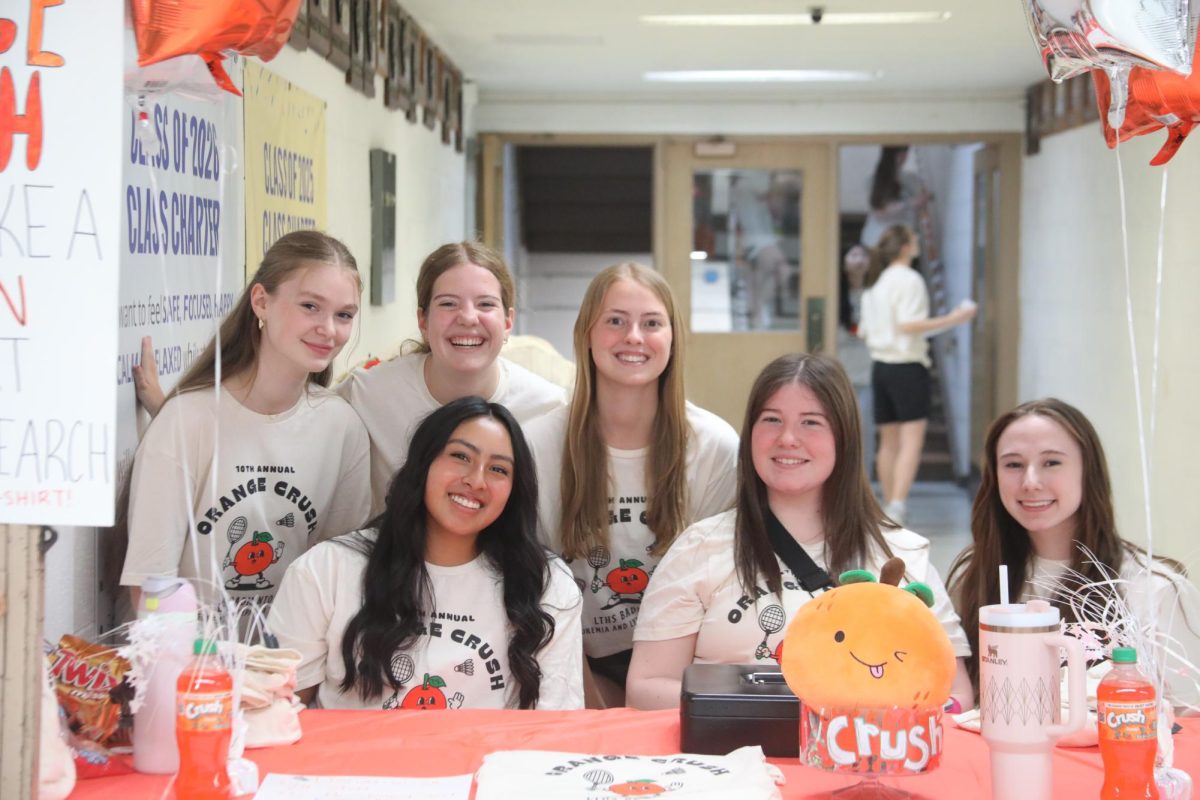 Varsity girls badminton players sell Orange Crush shirts in front of Upper Vaughan gyms on April 10 
