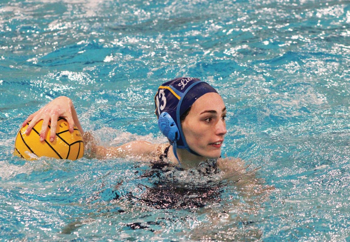 Bebe Wright '26 guards the ball from defense during varsity's game against Hinsdale Central on April 16 (Simmons/LION).
