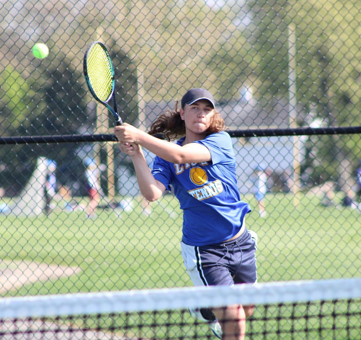 Mateja Nokic ‘28 lunges forward to forcefully strike the tennis ball against Neuqua Valley athletes on May 5 (Simmons/ LION).