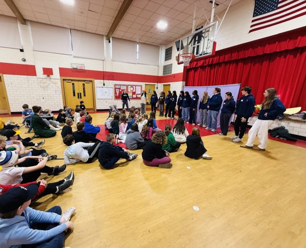 Project Snowball staff and theater leaders perform and comment on original skits to fifth and sixth graders in the Forest Hills Elementary gym on March 24 (photo courtesy of Shannon Berg)/