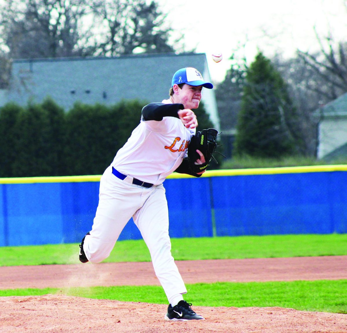 Right-hand pitcher Tucker King ‘25 throws a changeup to get a strikeout against Brother Rice High School on April 10 (Simmons/ LION).