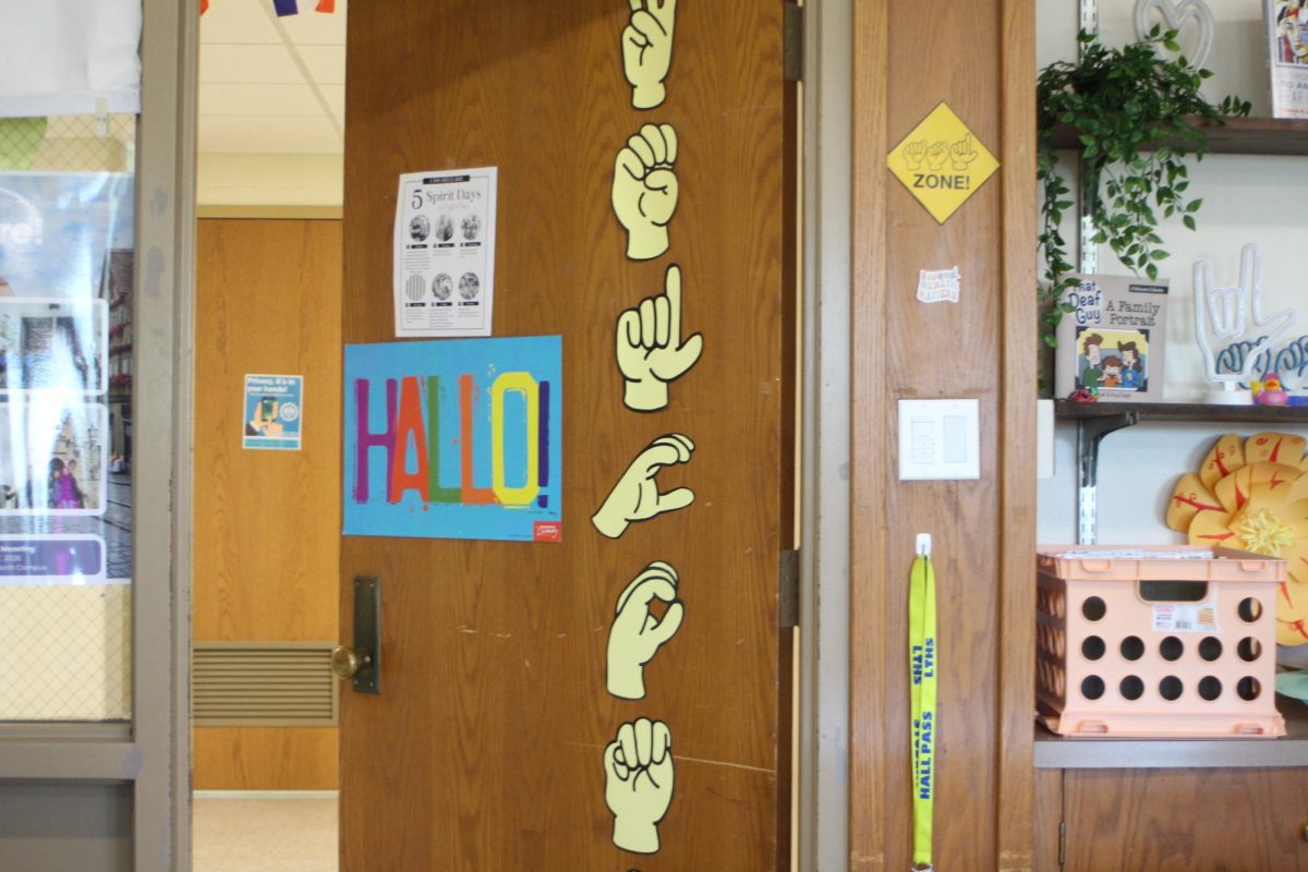 ASL letters spelling “welcome” on Conrad’s door (Velez/LION).
