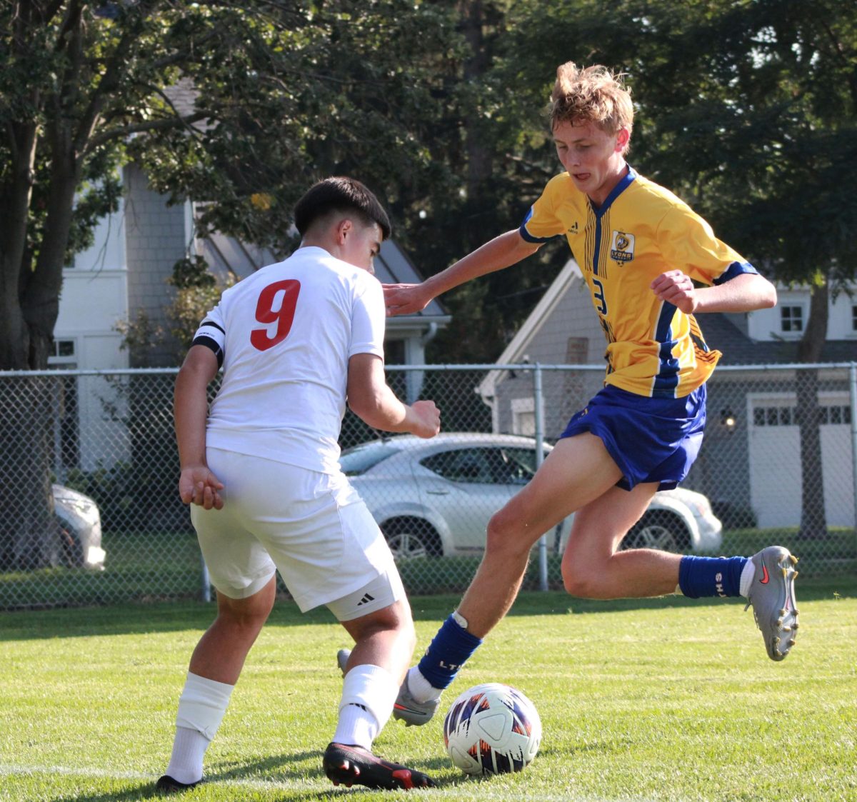 Defender Gavin Sullivan ‘26 jumps into the air to forcefully block the ball against a Benet adversary (Simmons/LION).