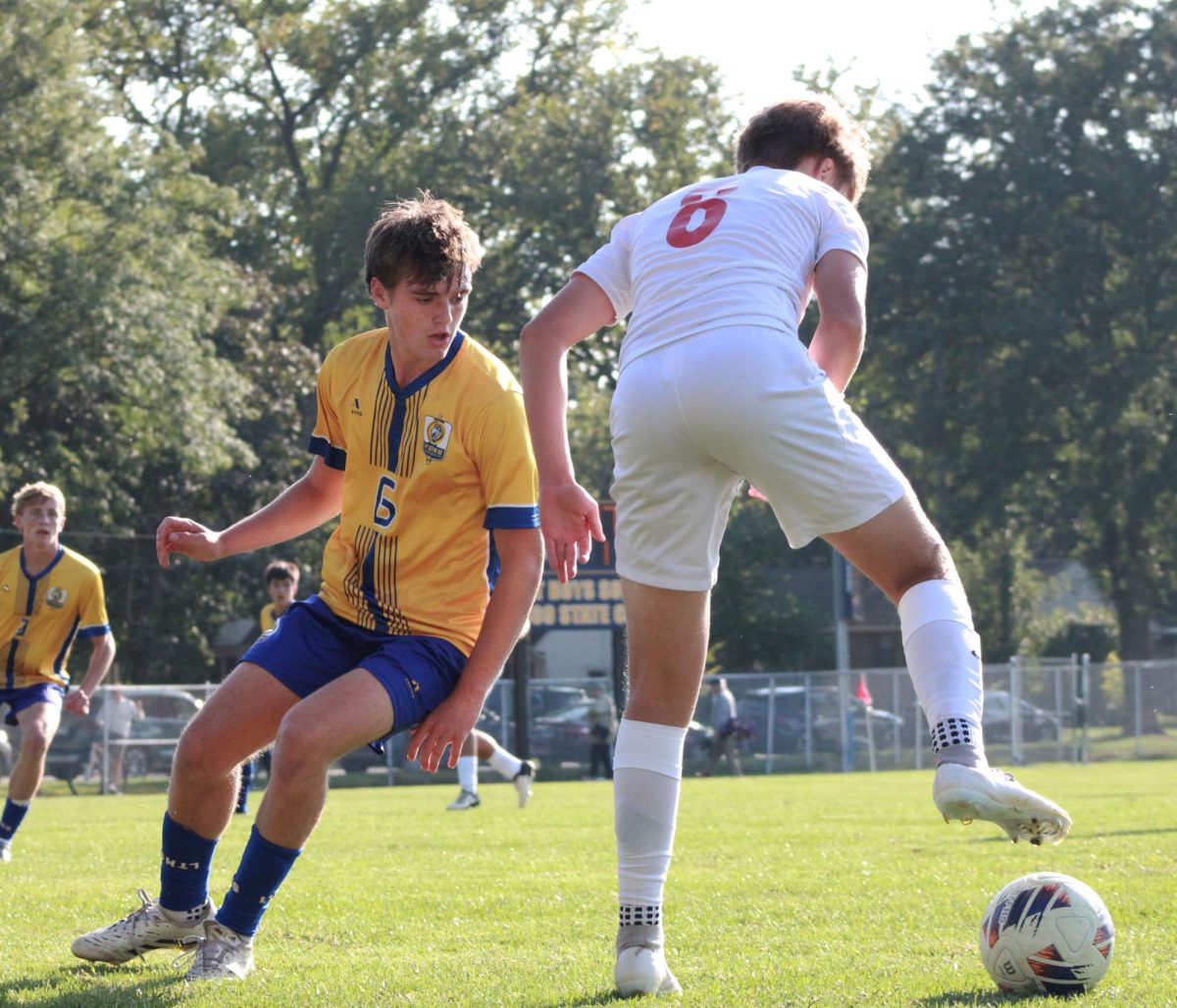 Midfielder Hayden McTigue ‘27 attempts to steal ball from Benet athlete during a game on Sept. 4 (Simmons/LION).