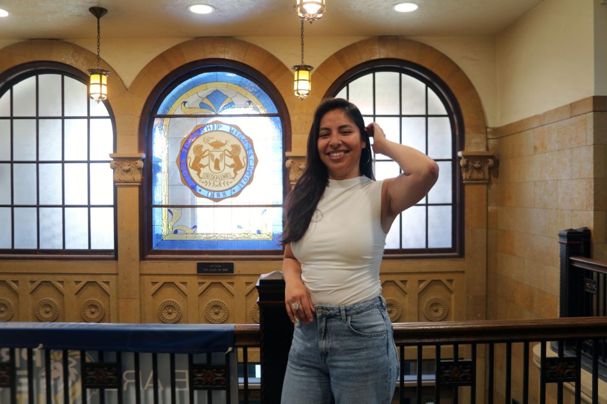 Ximena N. Beltram Quan Kui ‘05 strikes a pose inside of the NC clock tower (Brooks/LION).