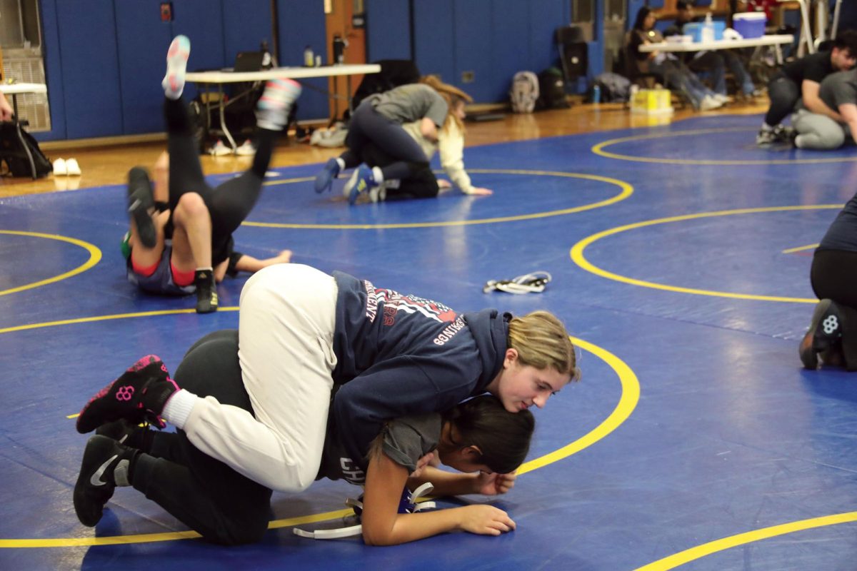 Tori Evans ‘28 tackles her teammate during practice on Dec. 2 (Stack/LION).