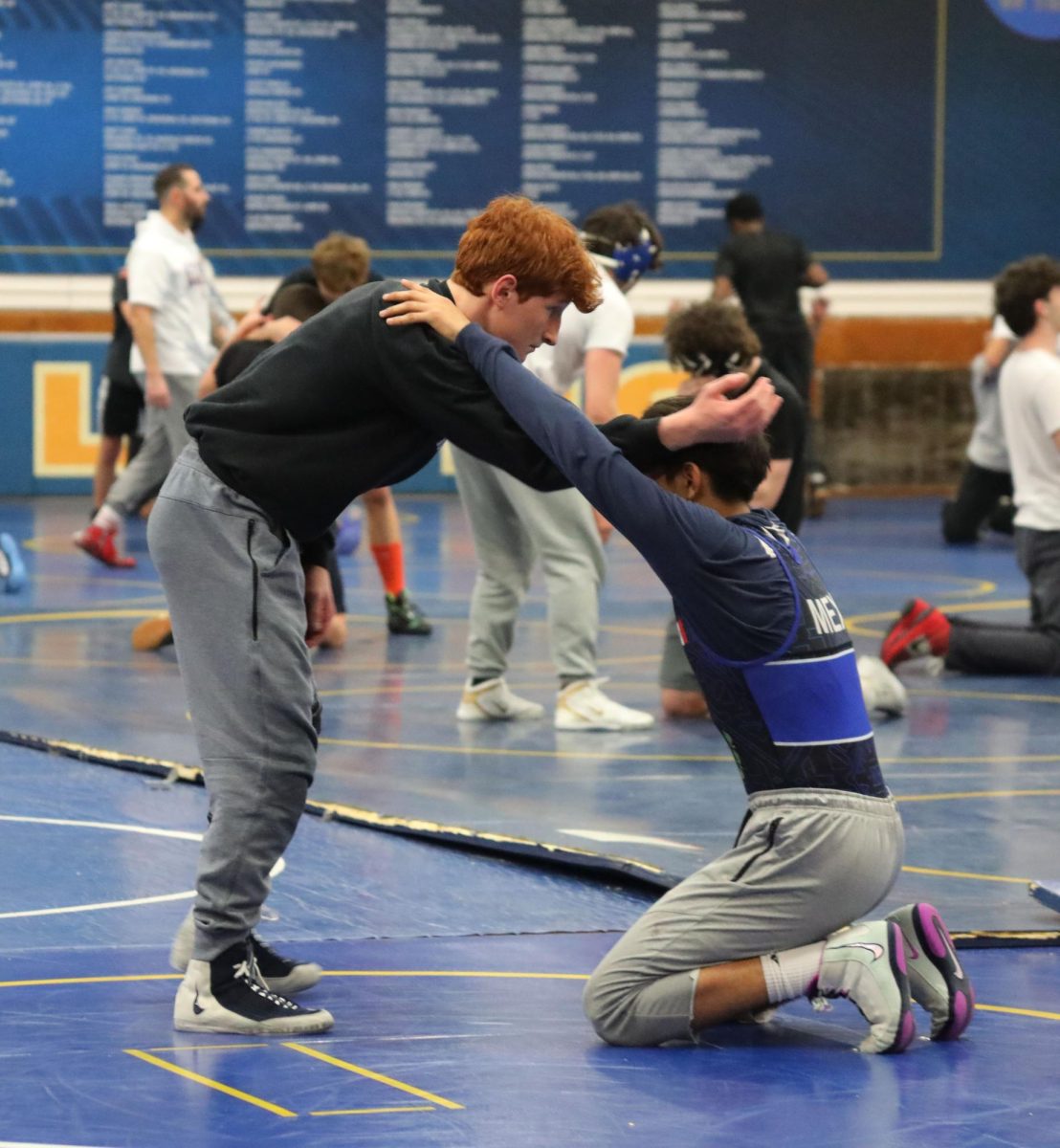 Griff Powell ‘26 puts his teammate into a headlock while practicing on Dec. 2 for an upcoming match (Stack/LION).