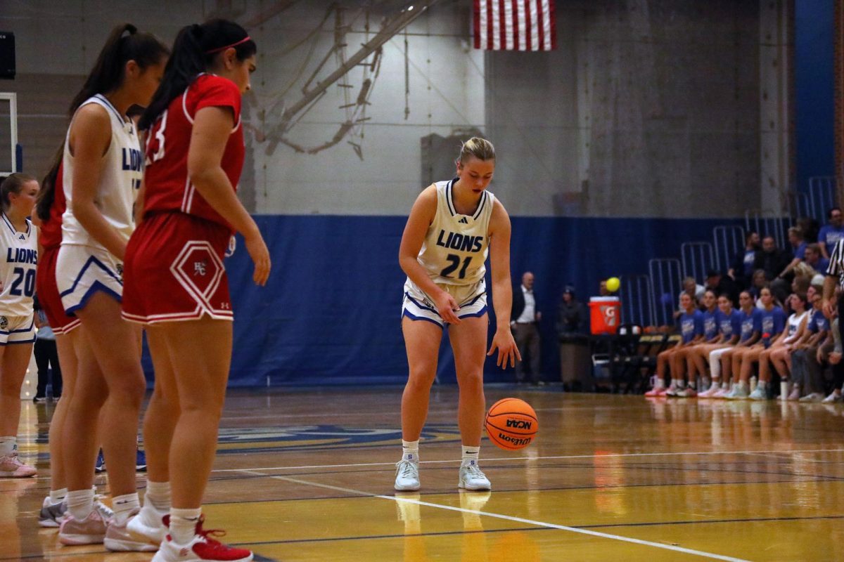 Gwen Smith ‘26 prepares a free throw on Dec. 2 at the staff Appreciation game against Hinsdale Central (Brooks/LION).