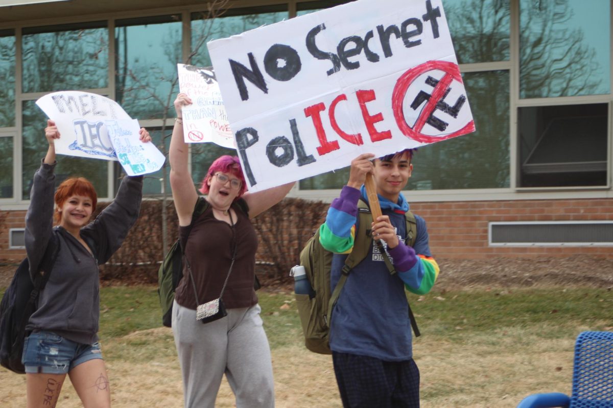 Student hoists sign that states “No Secret Police” with the ICE in police highlighted.