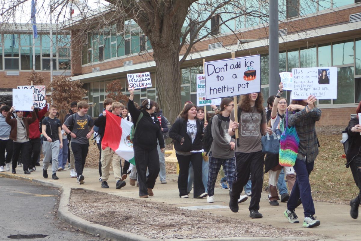  Students outside of SC with homemade signs, one reading “Don’t add ice to a melting pot”.