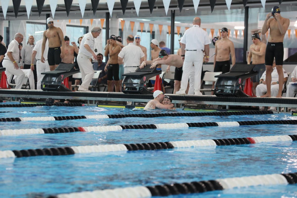 Patrick Rhatigan ‘26 and Matthew Ferguson ‘26 smile and hug after placing second and third in the 500 freestyle, respectively (Forebaugh/LION). 