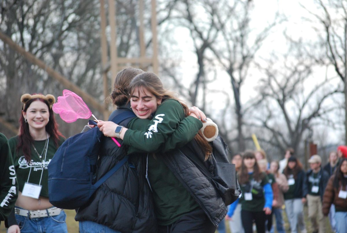 Two Snowball participants share a hug during an event (photo courtesy of Makenzie Lemna).