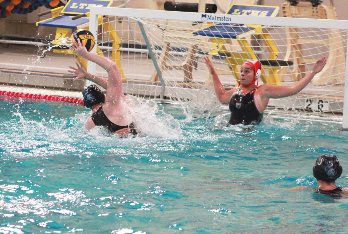 Bella Recker ‘26 shoots and scores against her OPRF opponent on April 20 (Simmons/LION). 