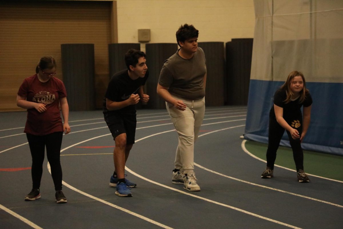 Macayla Gainer ‘28, Stanley Hides ‘26, Valentino Garcia ‘29, and Halina Foster ‘25 run in the SC Fieldhouse (Stack/LION).